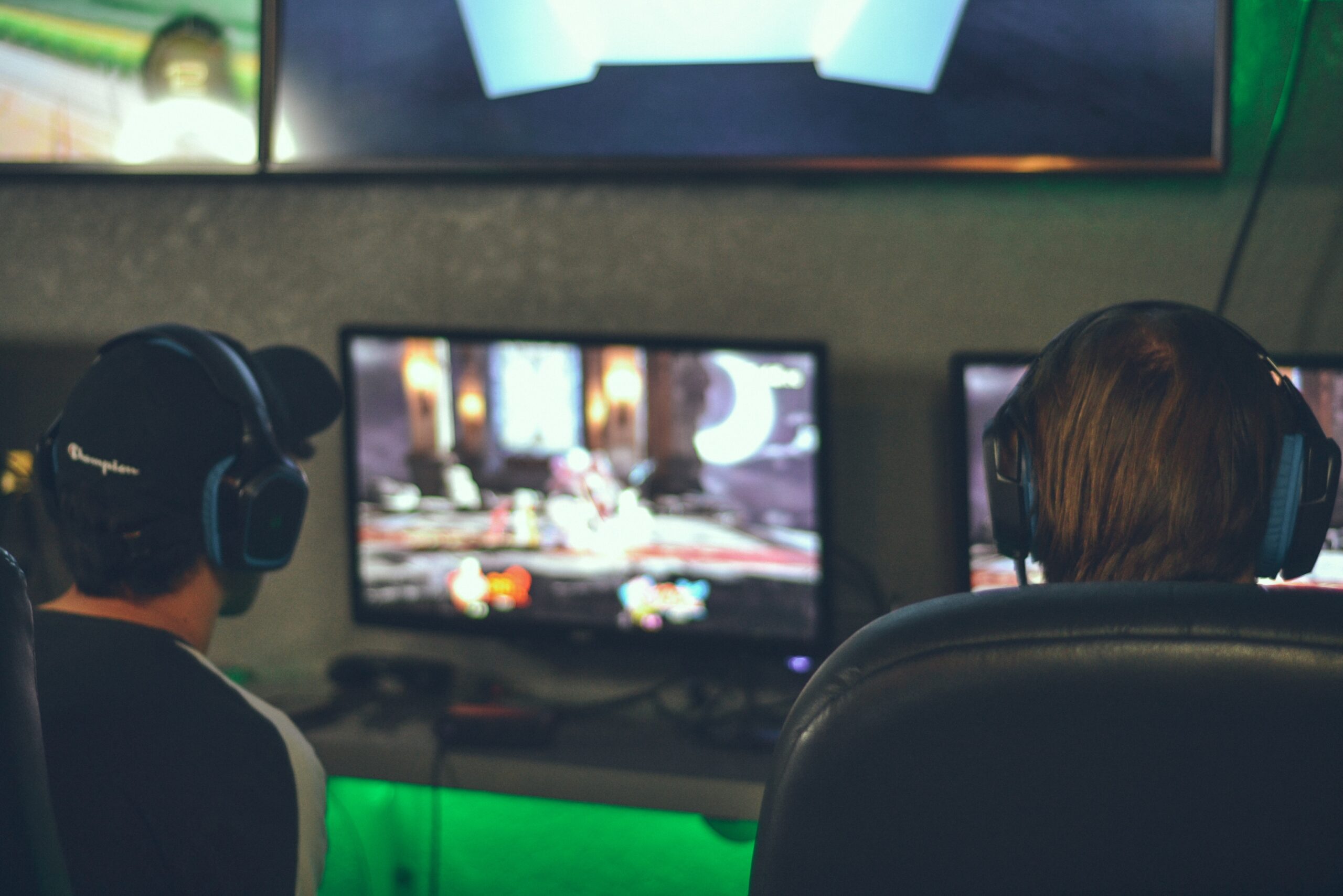 Deux joueurs avec casques devant écrans de jeu