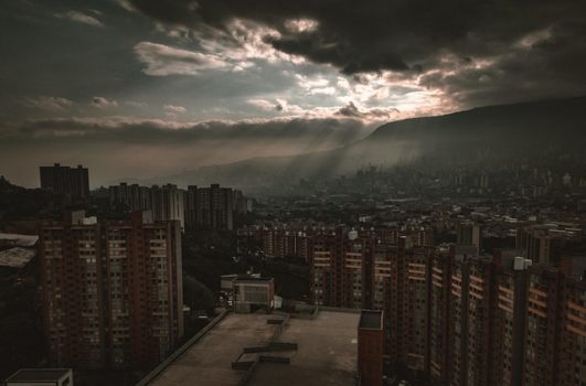 Ville sous ciel orageux avec rayons de soleil